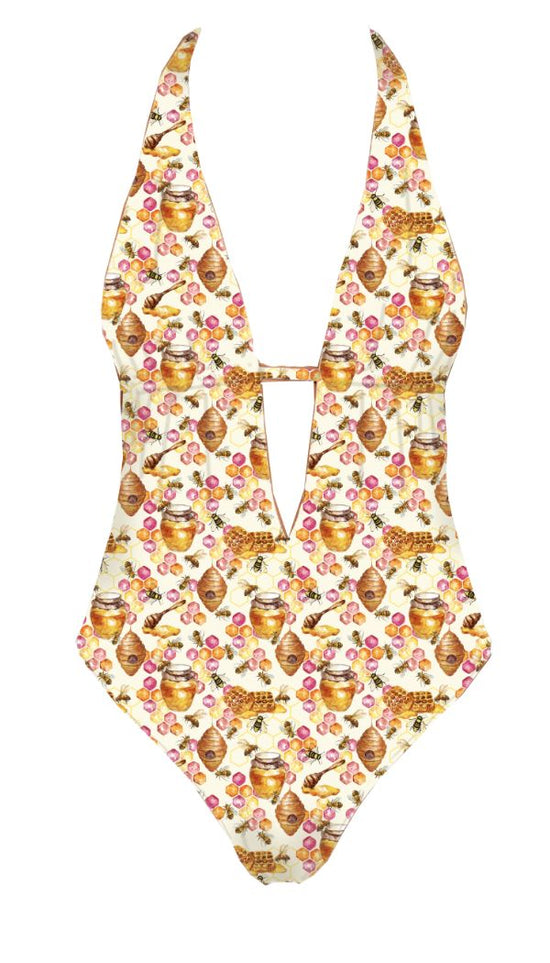 One-piece swimsuit with honeycomb and bee print on a white background